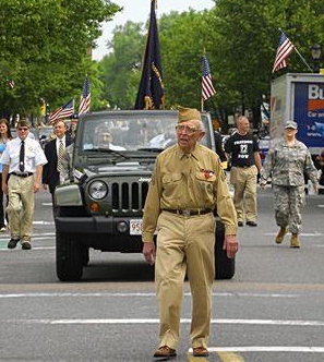 North Attleboro's Robert Greene, 83, a World War II veteran who served in the Army Signal Corps, marches in downtown North Attleboro during the towns Memorial Day parade on Saturday. (Staff photo by MARK STOCKWELL)
